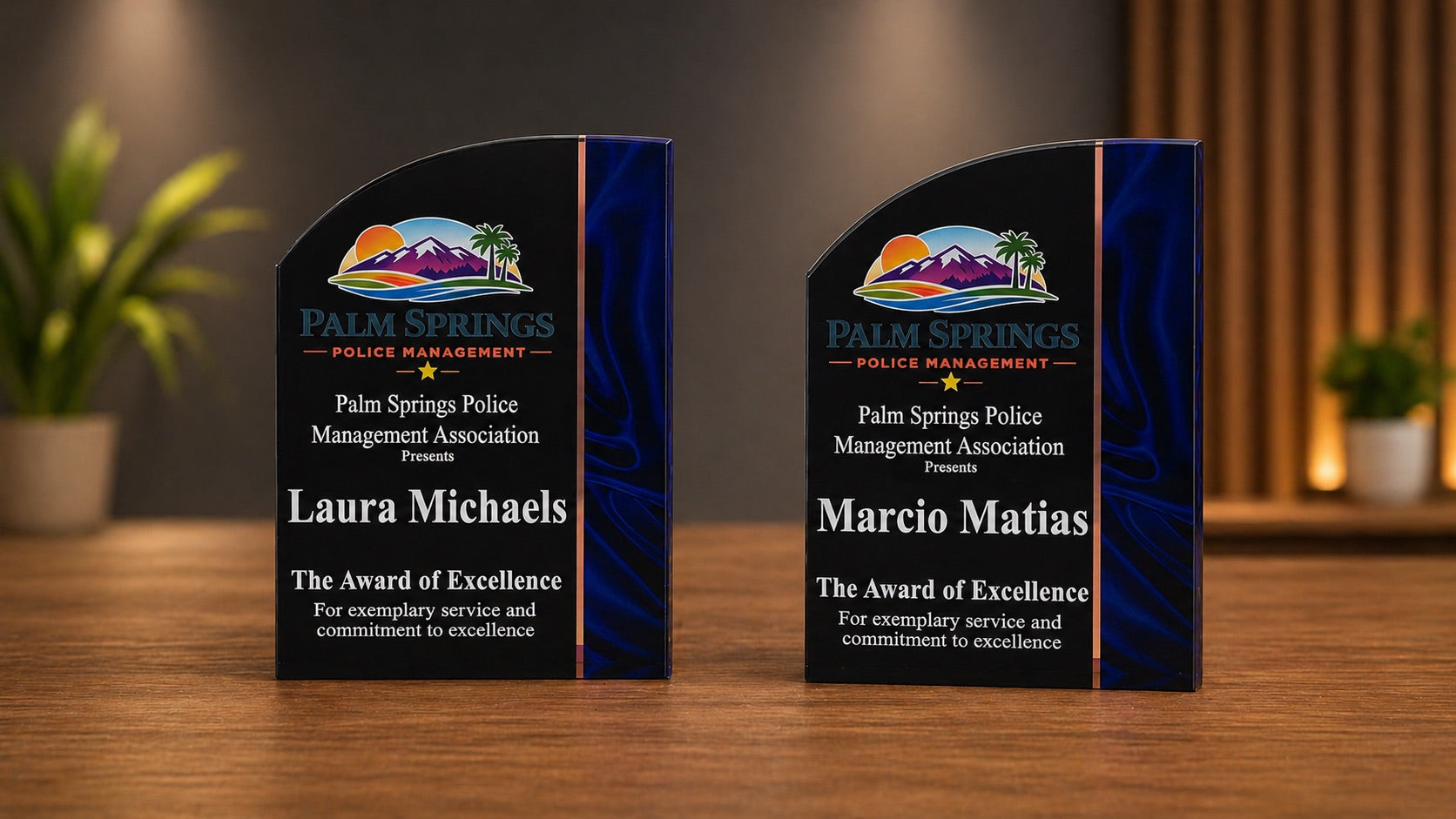 Two personalized standing recognition awards with black faces, blue accents, and full-color Palm Springs Police Management logos