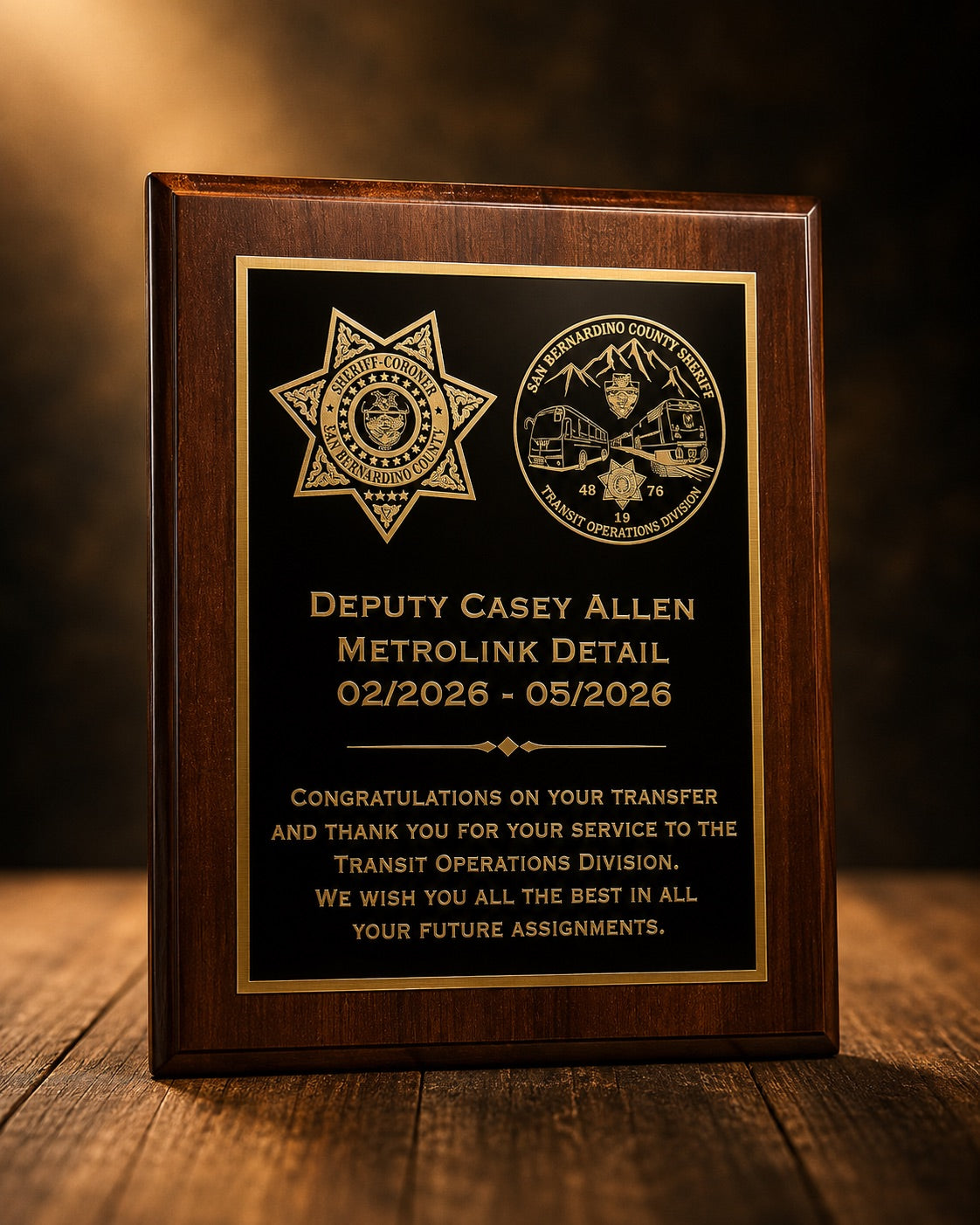 Wood recognition plaque with a black and gold dedication panel and two sheriff department emblems